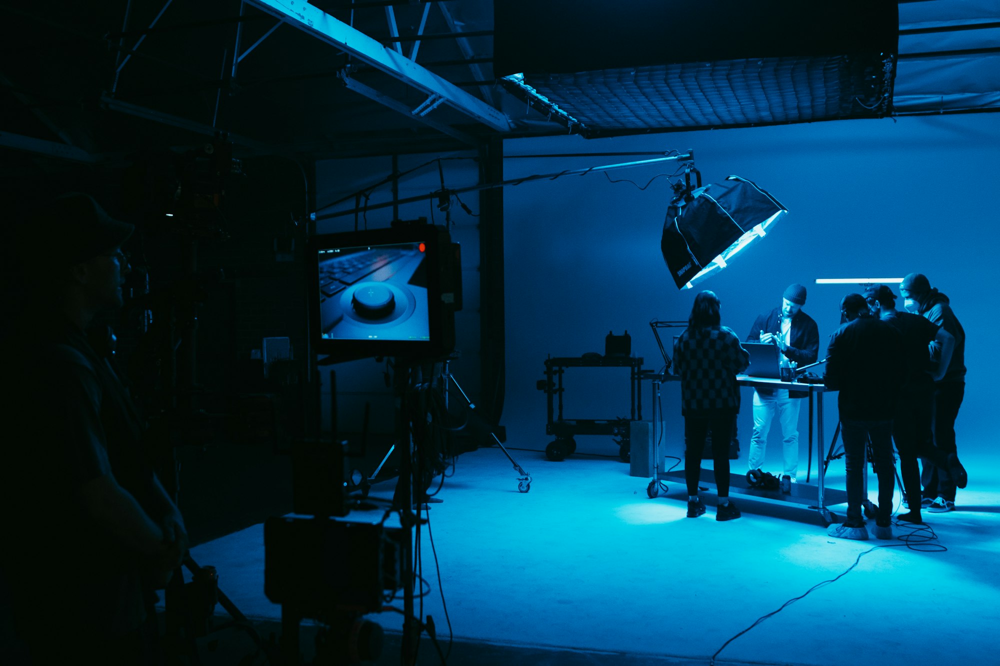 Crew in a blue-lit studio
